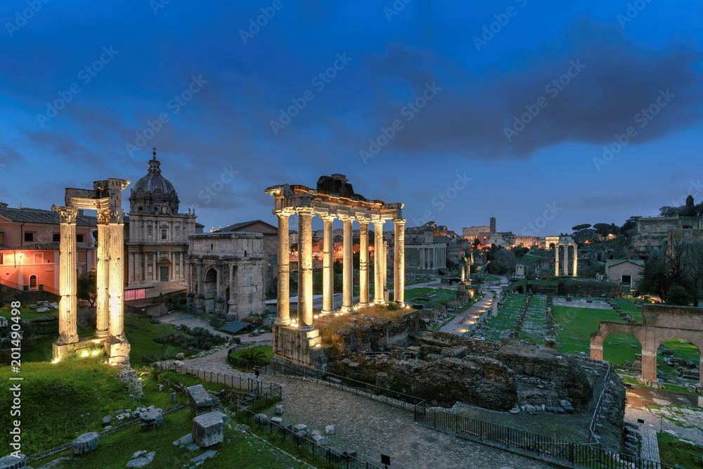 Rome Forum with ruins of ancient architecture at night. Italy.