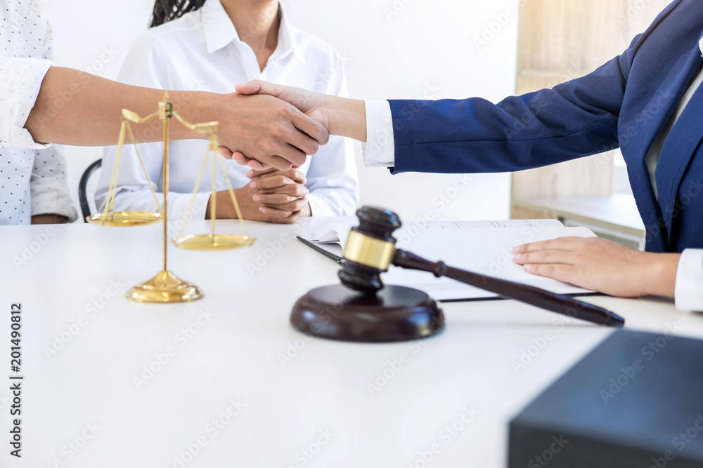 Handshake after good cooperation greeting, Having meeting with team at law firm, Consultation between a female lawyer and businessman customer, tax and the company of real estate concept