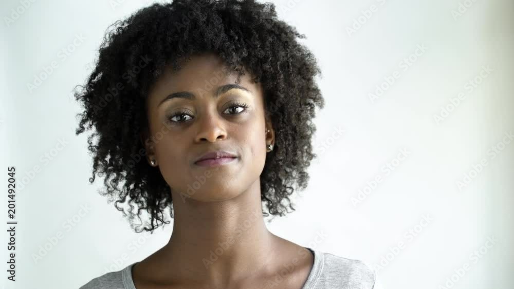 Young woman with afro looking at camera and shaking head. Young woman with afro looking at camera and shaking head.