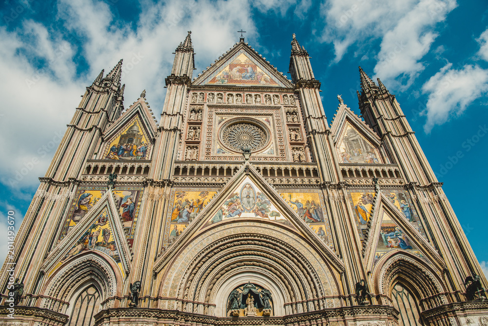 low angle view of facade of ancient historical Orvieto Cathedral in Orvieto, Rome suburb, Italy