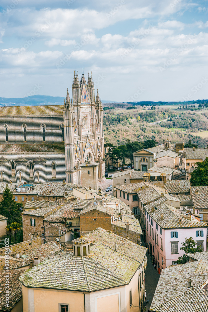 aerial view of ancient historical Orvieto Cathedral and roofs of buildings in Orvieto, Rome suburb, Italy