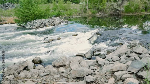 3 in 1. Set of footages with water flowing through rocks. Boiling water in the river photo