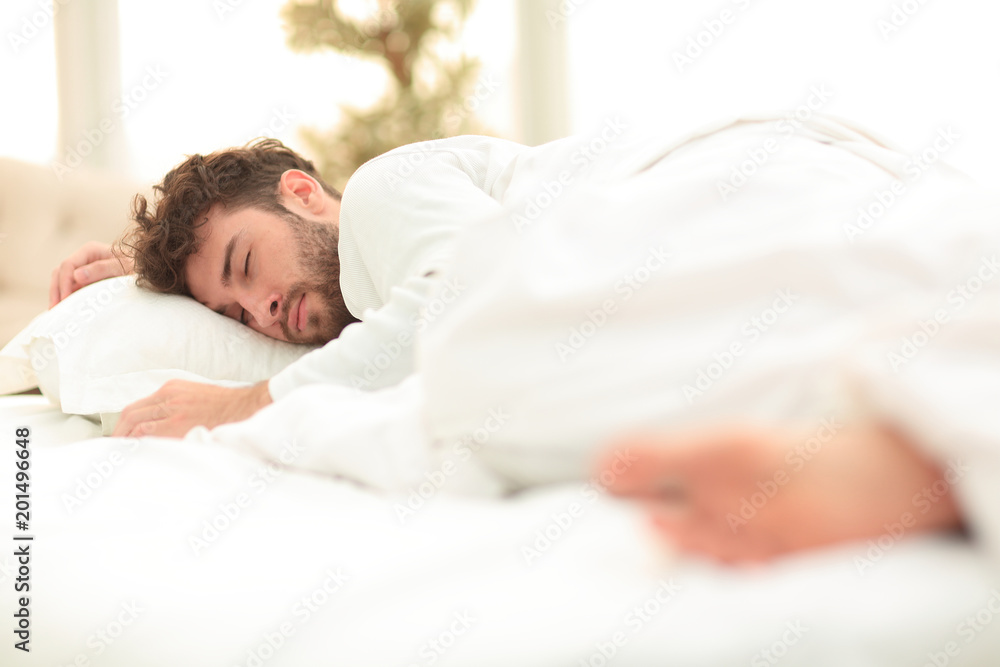 closeup.the tired men sleep soundly on the bed closeup.the tired men sleep soundly on the bed