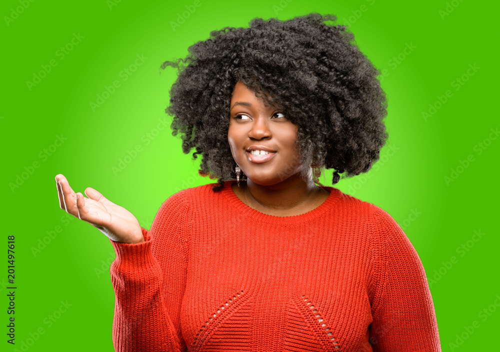Beautiful african woman holding something in his empty hand Beautiful african woman holding something in his empty hand