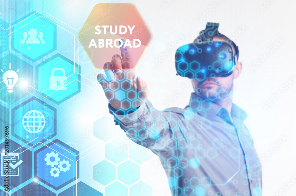 The concept of business, technology, the Internet and the network. A young entrepreneur working on a virtual screen of the future and sees the inscription: Study abroad
