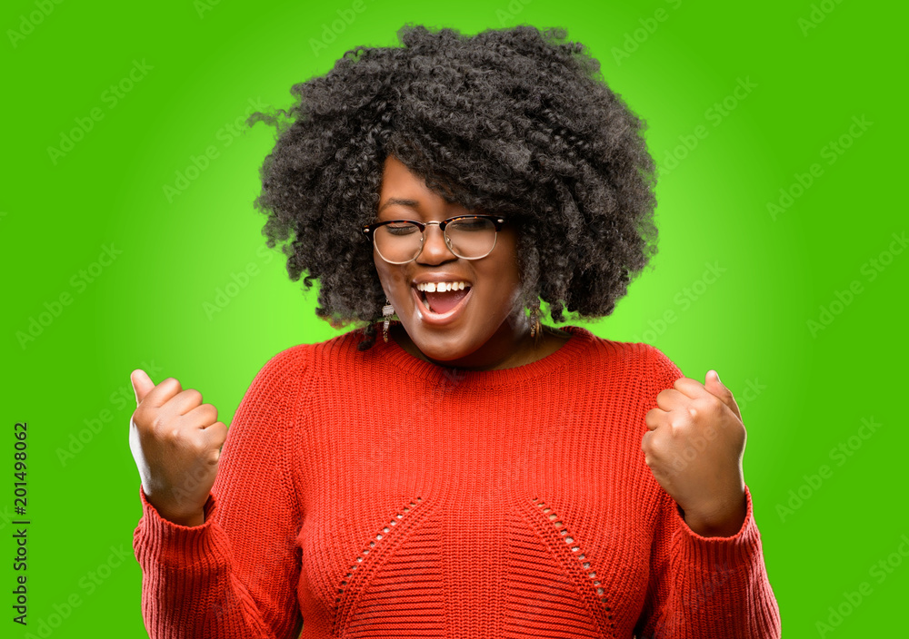 Beautiful african woman happy and excited celebrating victory expressing big success, power, energy and positive emotions. Celebrates new job joyful Beautiful african woman happy and excited celebrating victory expressing big success, power, energy and positive emotions. Celebrates new job joyful