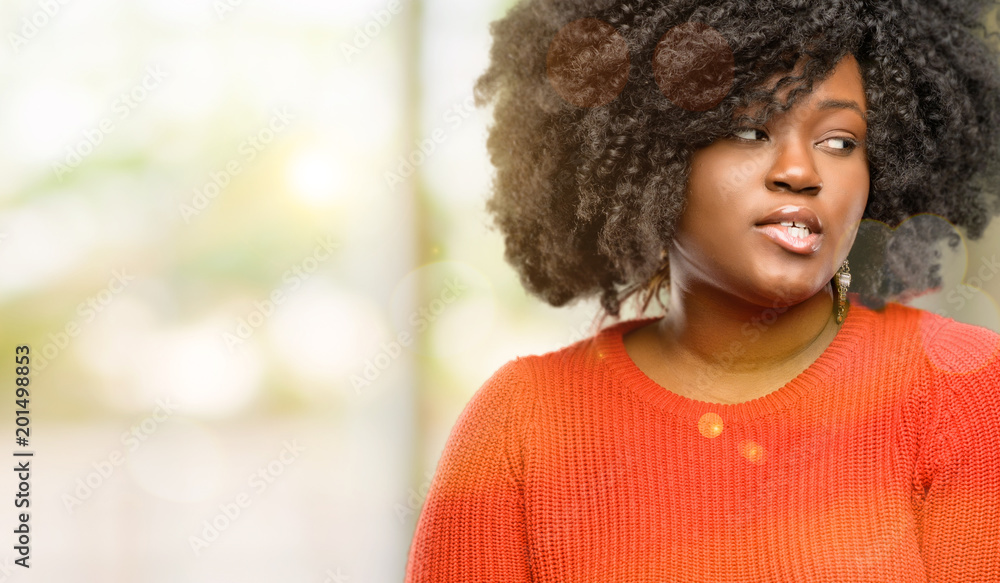 Beautiful african woman confident and happy with a big natural smile looking side, outdoor Beautiful african woman confident and happy with a big natural smile looking side, outdoor