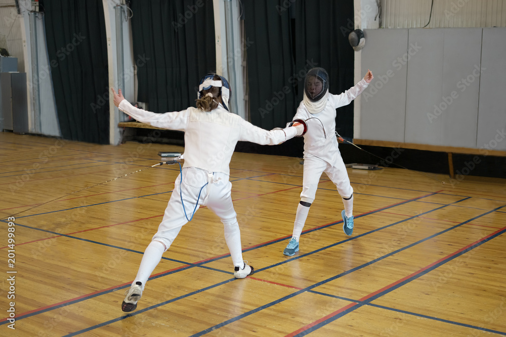 Girls, participants in fencing competitions are fighting on swords