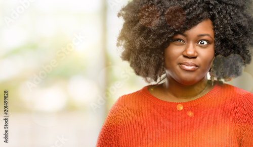 Beautiful african woman making funny face fooling, outdoor