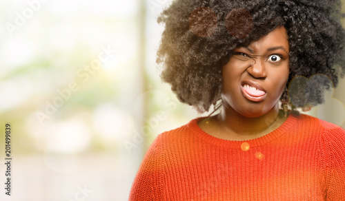 Beautiful african woman making funny face fooling, outdoor