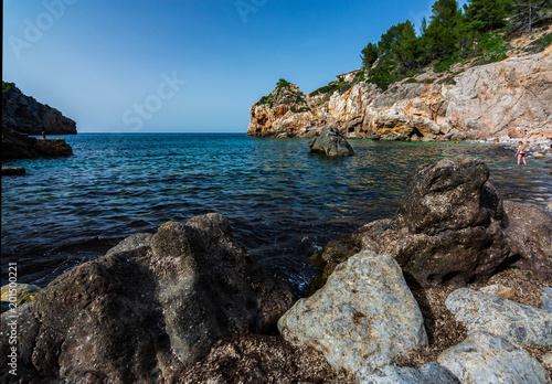 Fototapeta Naklejka Na Ścianę i Meble -  Rocks in the foreground on small mediterranean beach. Mallorca, Spain