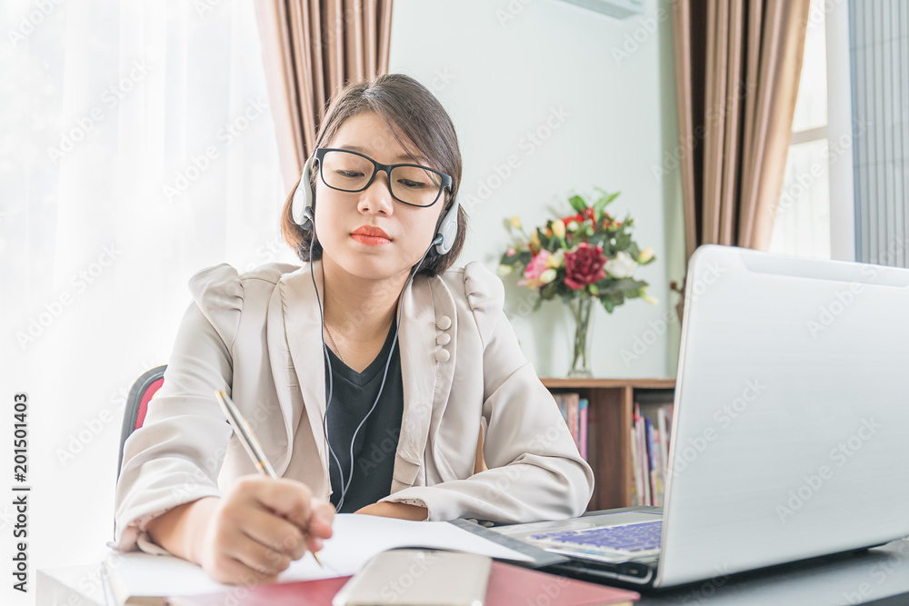 Teenage girl working on laptop in home office Teenage girl working on laptop in home office