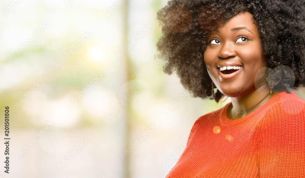 Obraz premium Beautiful african woman happy and surprised cheering expressing wow gesture, outdoor