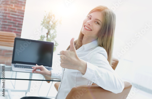 smiling female assistant shows thumb up