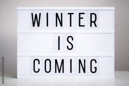 Принти на полотні lightbox with text winter is coming on the table