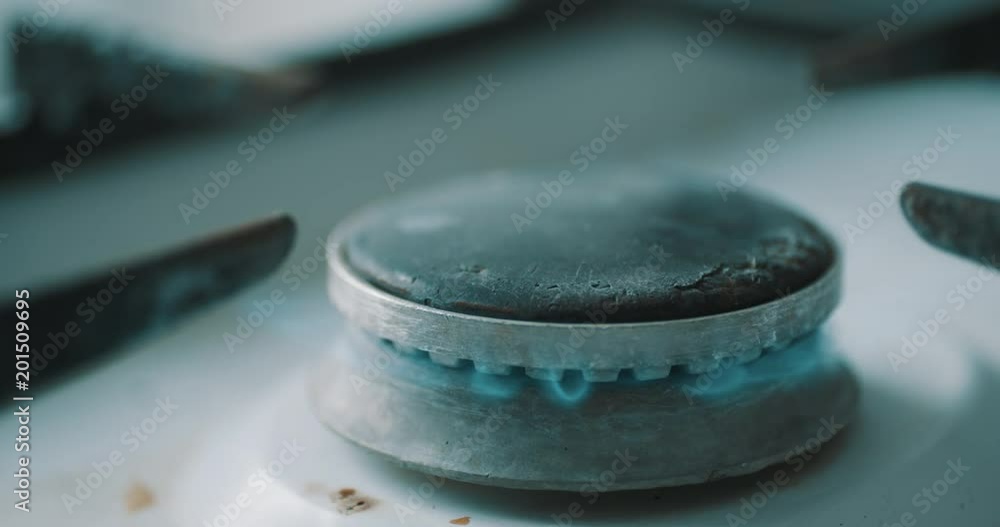 Stove burner igniting into blue cooking flame in slow motion Stove burner igniting into blue cooking flame in slow motion