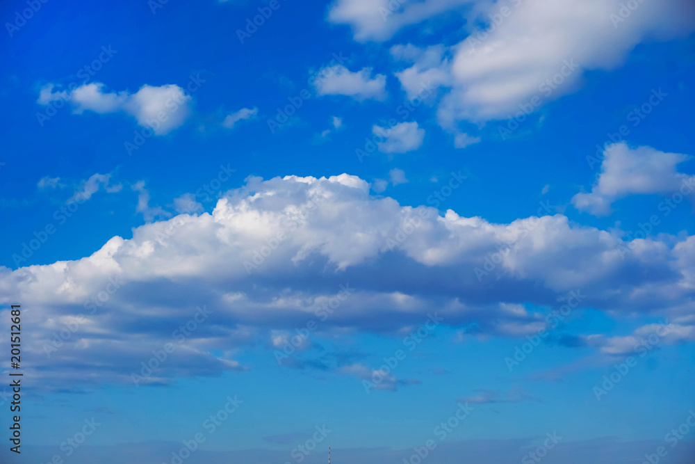 background texture of white clouds in a bright blue spring sky