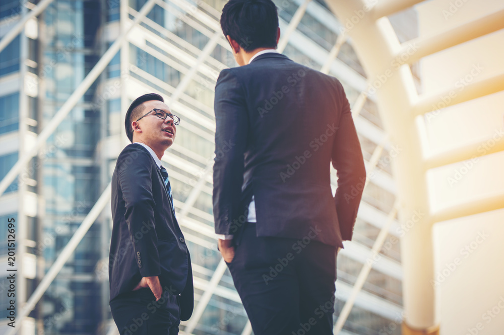 Businessmen meeting on the stairs.