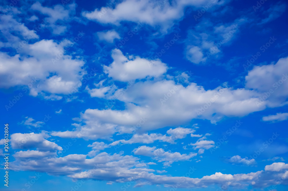 gentle white clouds in a bright blue spring sky gentle white clouds in a bright blue spring sky