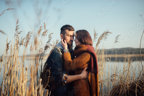 young loving couple on the lake near the reeds