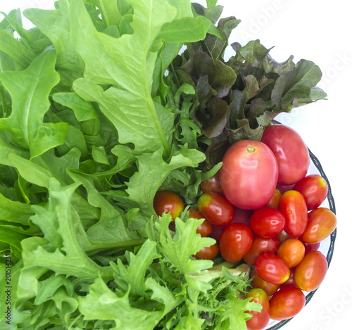 fresh organic of colorful mix vegetables isolate on white background, green and red lettuce, mizuna lettuce, cherry tomato, ingredients are preparing in the blow for cooking, healty