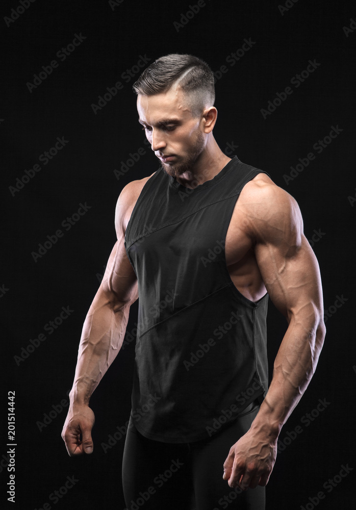 Portrait of a muscular male model against black background Portrait of a muscular male model against black background