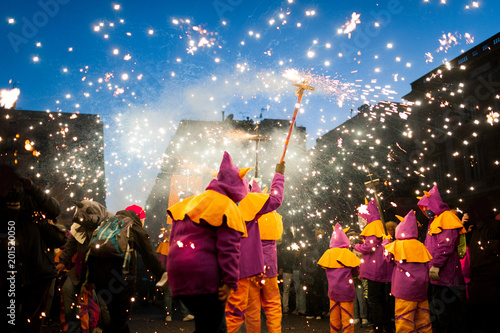 Photography traditional catalan correfocs celebration with fireworks and people dressed like