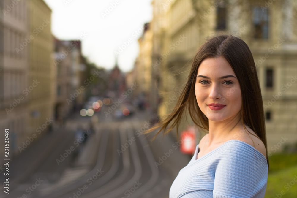 Young girl portrait in city in spring