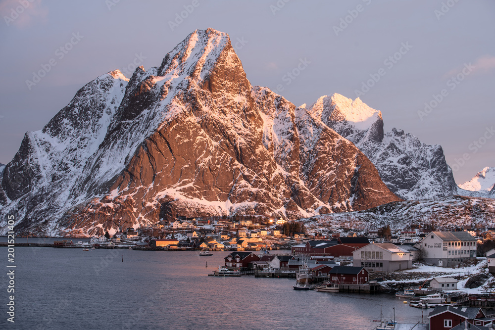 Reine Village in the morning with stunning sunrise scene of the day one of the most famous village in Lofoten , Norway / Travel concept / Landscape Photography