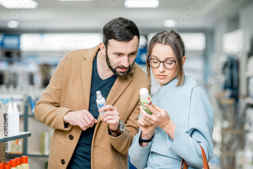Couple choosing medicine in the pharmacy store