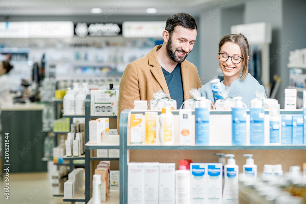 Couple choosing cosmetics in the pharmacy Couple choosing cosmetics in the pharmacy