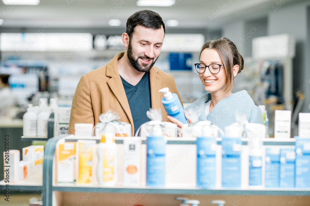 Couple choosing cosmetics in the pharmacy Couple choosing cosmetics in the pharmacy