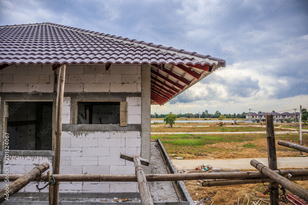 Fototapeta premium construction residential new house in progress at building site
