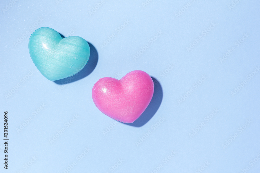 Obraz premium Couple of heart shape over blue table. Romantic Valentine Day concept with copy space