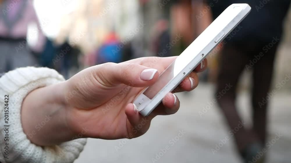 Close-Up Shot Of Woman's Hands Using mobile phone In Busy Public Place Close-Up Shot Of Woman's Hands Using mobile phone In Busy Public Place