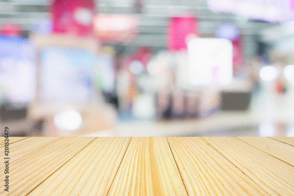 wood table top with eletronic department store show Television TV and home appliance with bokeh light blurred background