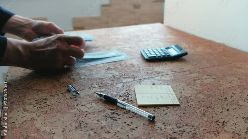 Man counts the money on the table. Closeup hands. Man counts the money on the table. Closeup hands.