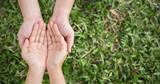 Close up open hands of man and woman with palm up. Together helping environment protection and caring concept banner.