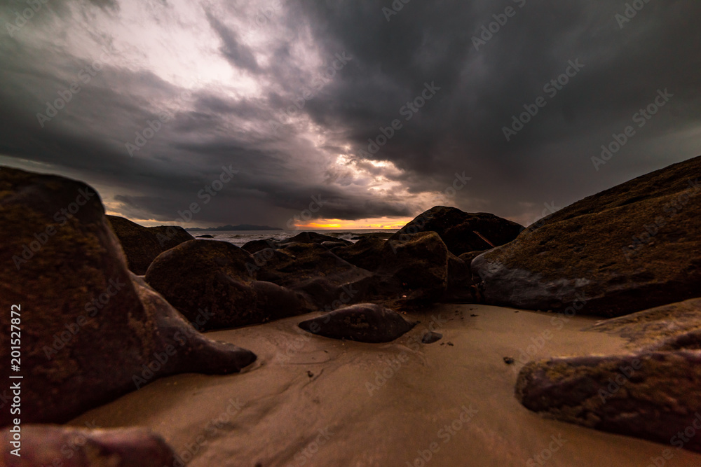 The rocks on the beach are stormy.