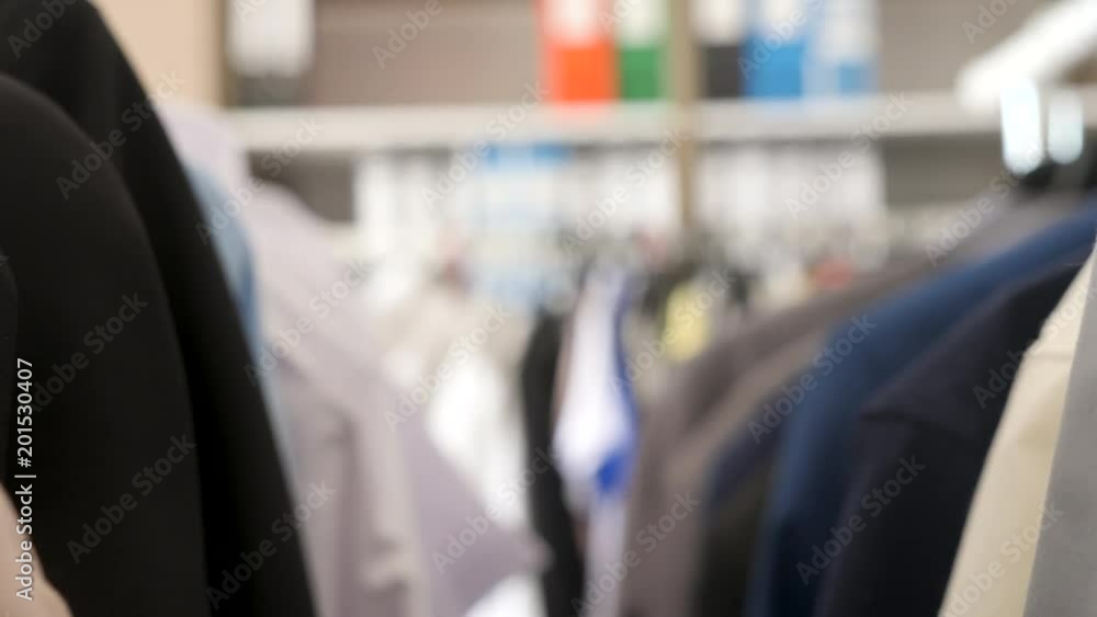 Going through hangers with clothes in a store. Dolly footage Going through hangers with clothes in a store. Dolly footage