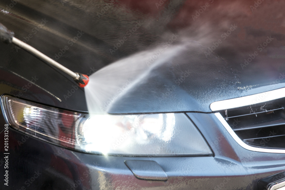 Obraz premium washing machine clean water jet aimed at the included headlight, close-up photo