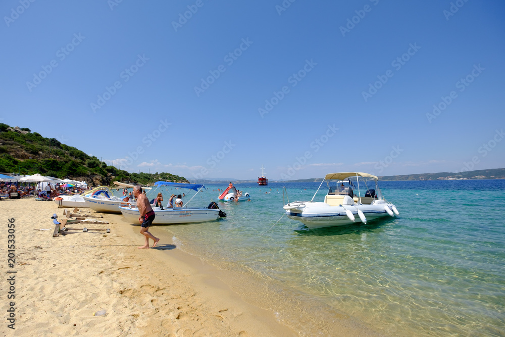 A beach and small boats in shallow water