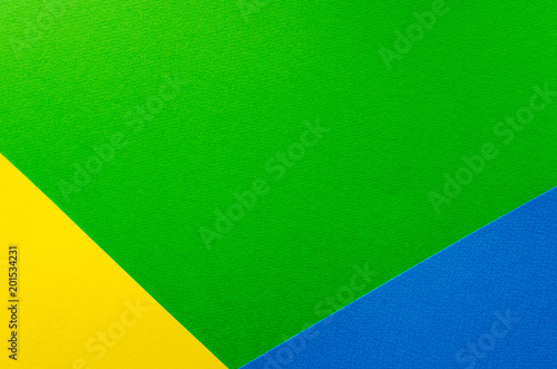 Colored geometric green, yellow, blue paper texture background.