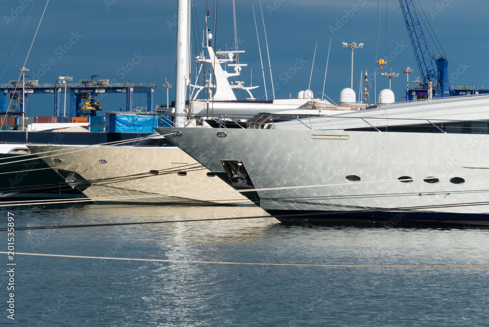 Naklejka premium Nice view of the luxury yachts in the port of valencia spain with the blue sky and clouds at sunset