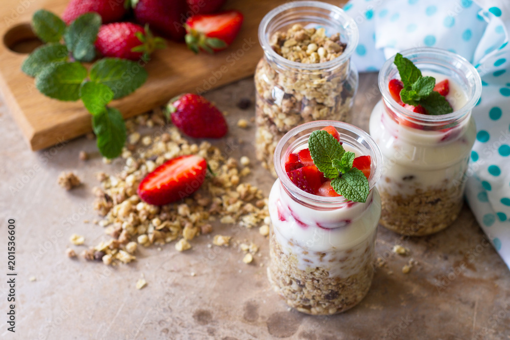 Homemade healthy breakfast with homemade baked granola, fresh strawberry and yogurt on stone or concrete table. Copy space. Homemade healthy breakfast with homemade baked granola, fresh strawberry and yogurt on stone or concrete table. Copy space.