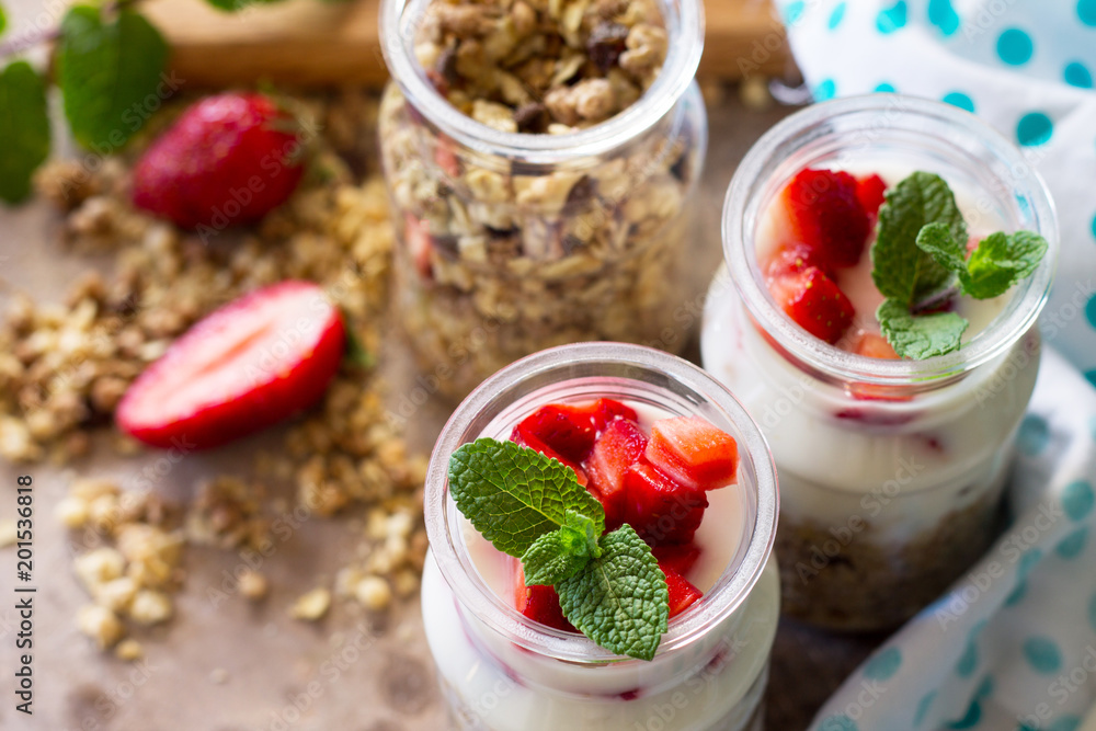 Homemade healthy breakfast with homemade baked granola, fresh strawberry and yogurt close-up on stone or concrete table. Homemade healthy breakfast with homemade baked granola, fresh strawberry and yogurt close-up on stone or concrete table.