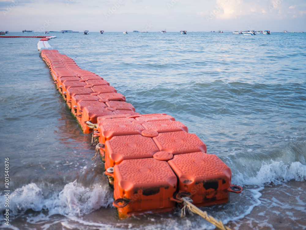 Fototapeta premium Floating wave breaker and rope on beach