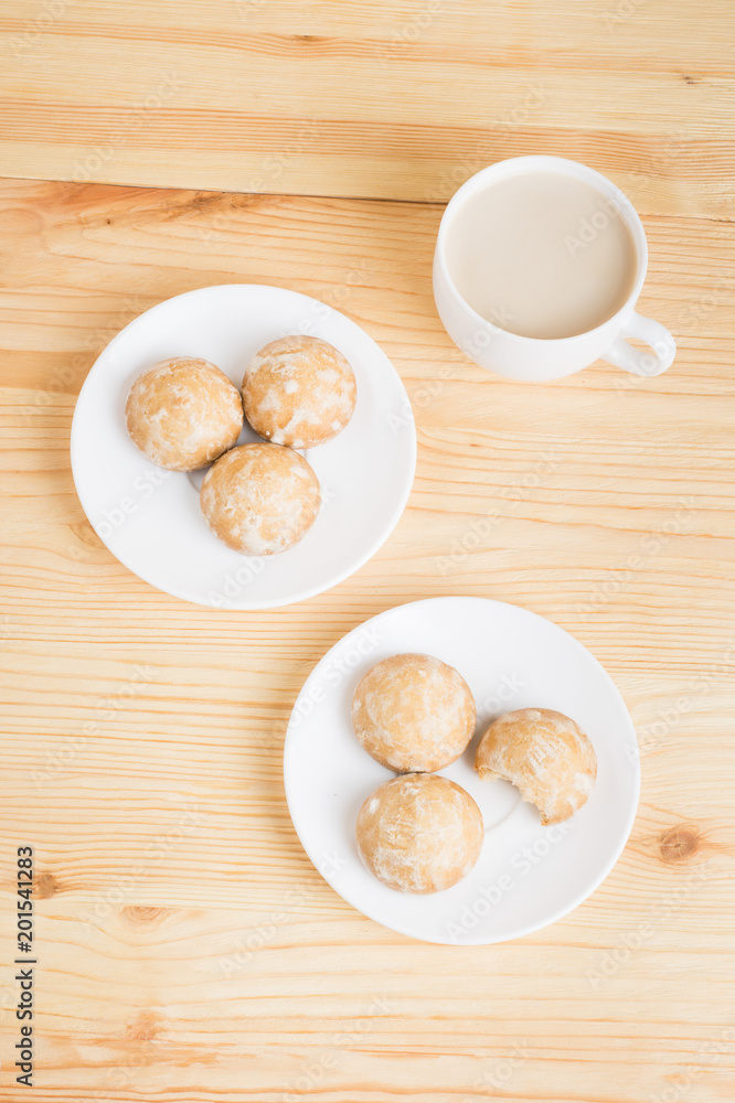 gingerbread on plates and coffee wiht milk on a wooden background. breakfast or snack gingerbread on plates and coffee wiht milk on a wooden background. breakfast or snack
