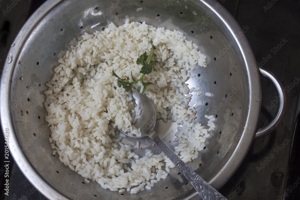 poured cooked rice in an old colander close poured cooked rice in an old colander close