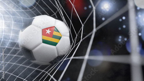 Realistic soccer ball in the net with the flag of Togo. series 